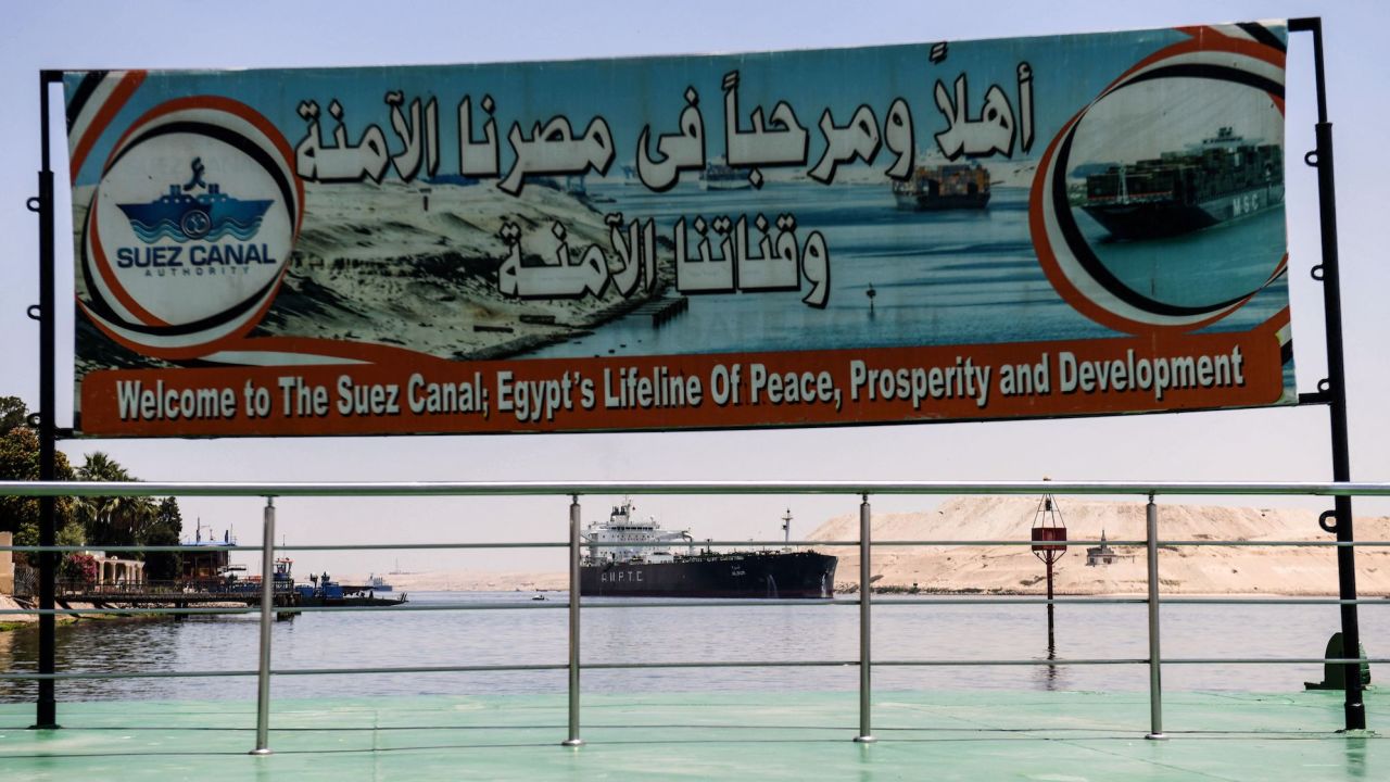 A welcoming sign is placed on the shore of the Suez Canal in the northeastern Egyptian city of Ismailiya, on May 27, 2021.
